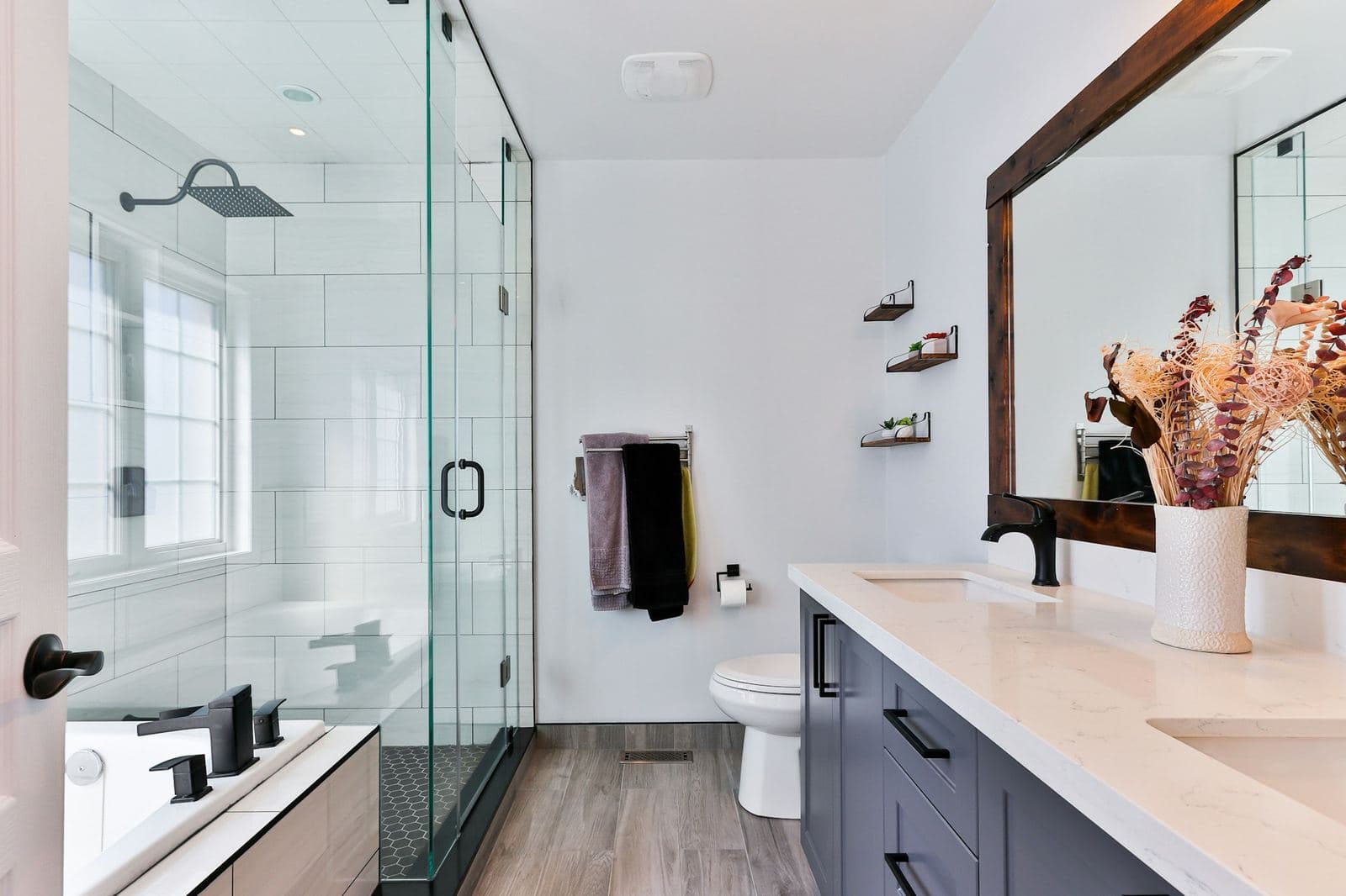 Bright bathroom with a frameless glass walk-in shower and a double vanity